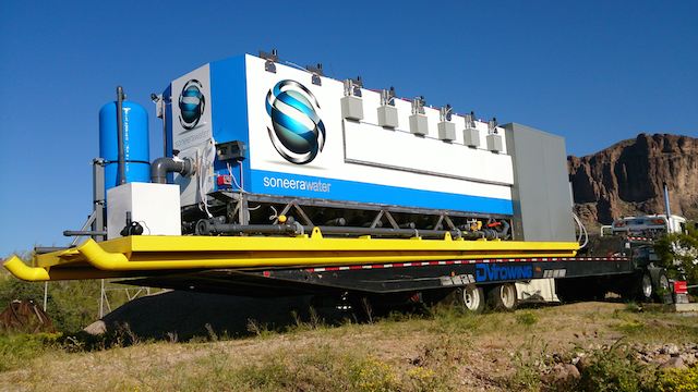 A skid-mounted, Soneera-branded treatment unit loaded on a trailer, ready for deployment